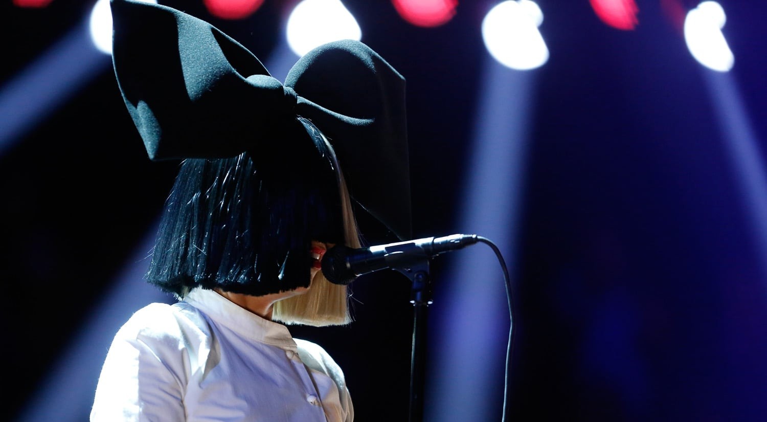 Sia performing with signature wig covering face